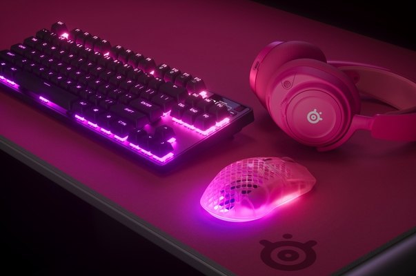 A magenta SteelSeries Aerox 3 Wireless Gen 2 gaming mouse in a styled scene