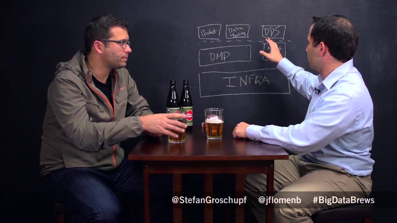 Stefan Groschupf, left, talks with investor Jake Flomenberg beside a chalkboard during Big Data & Brews.