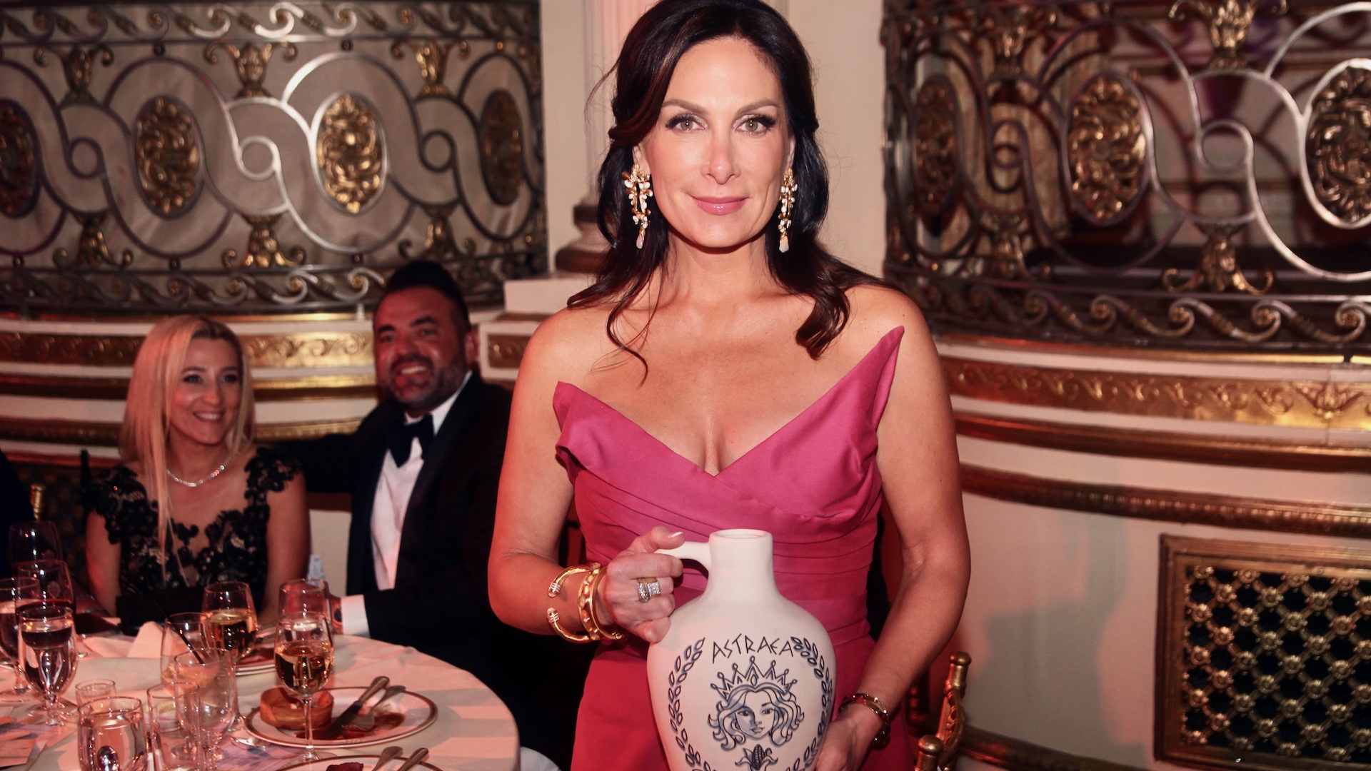 Stefanie Roumeliotes holding an Astraea-themed award at the 2025 Gabby Awards