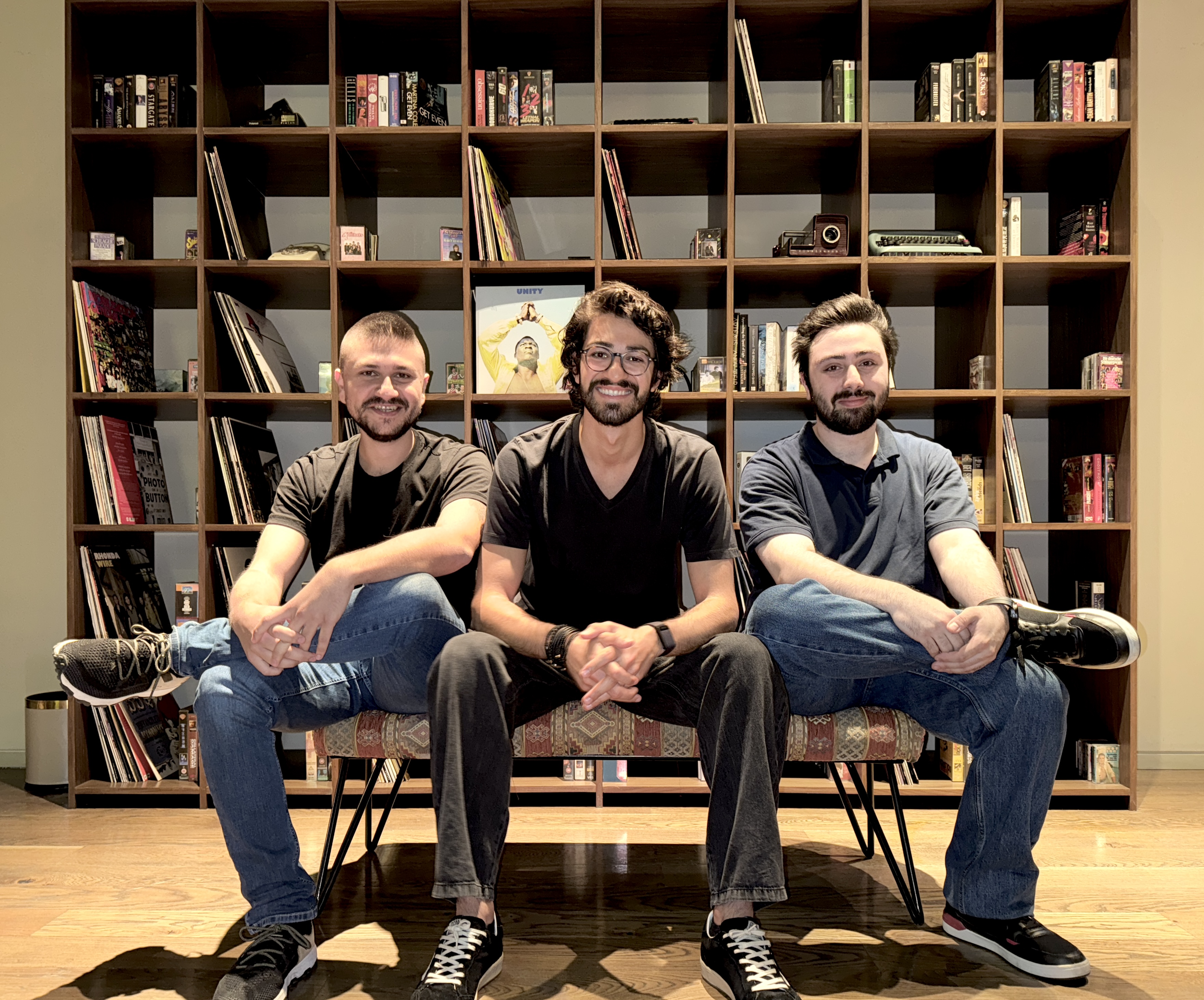 Podeo co-founders Mario Hayek, Stefano Fallaha and Anthony Essaye seated together in front of shelves of books and records