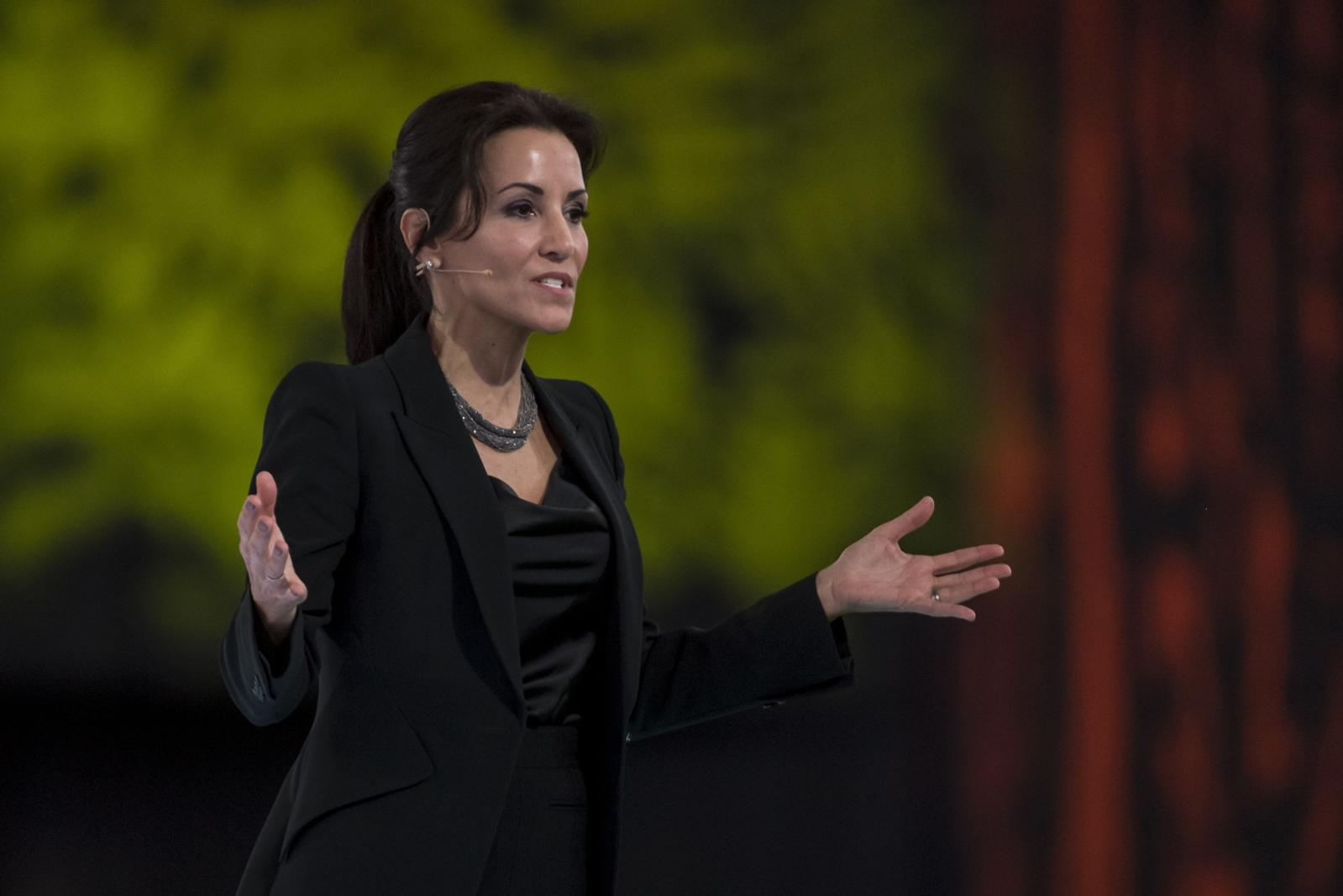 Stephanie Buscemi speaking on a conference stage