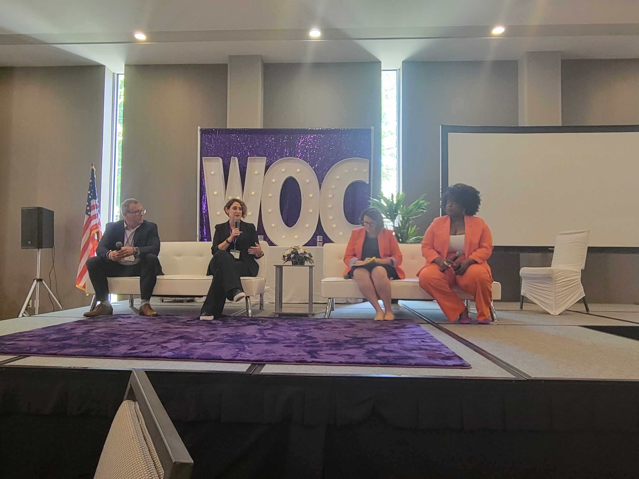 Stephanie Crockett speaks into a microphone during a panel at the 2024 Women of Color Summit in Niagara Falls, New York.
