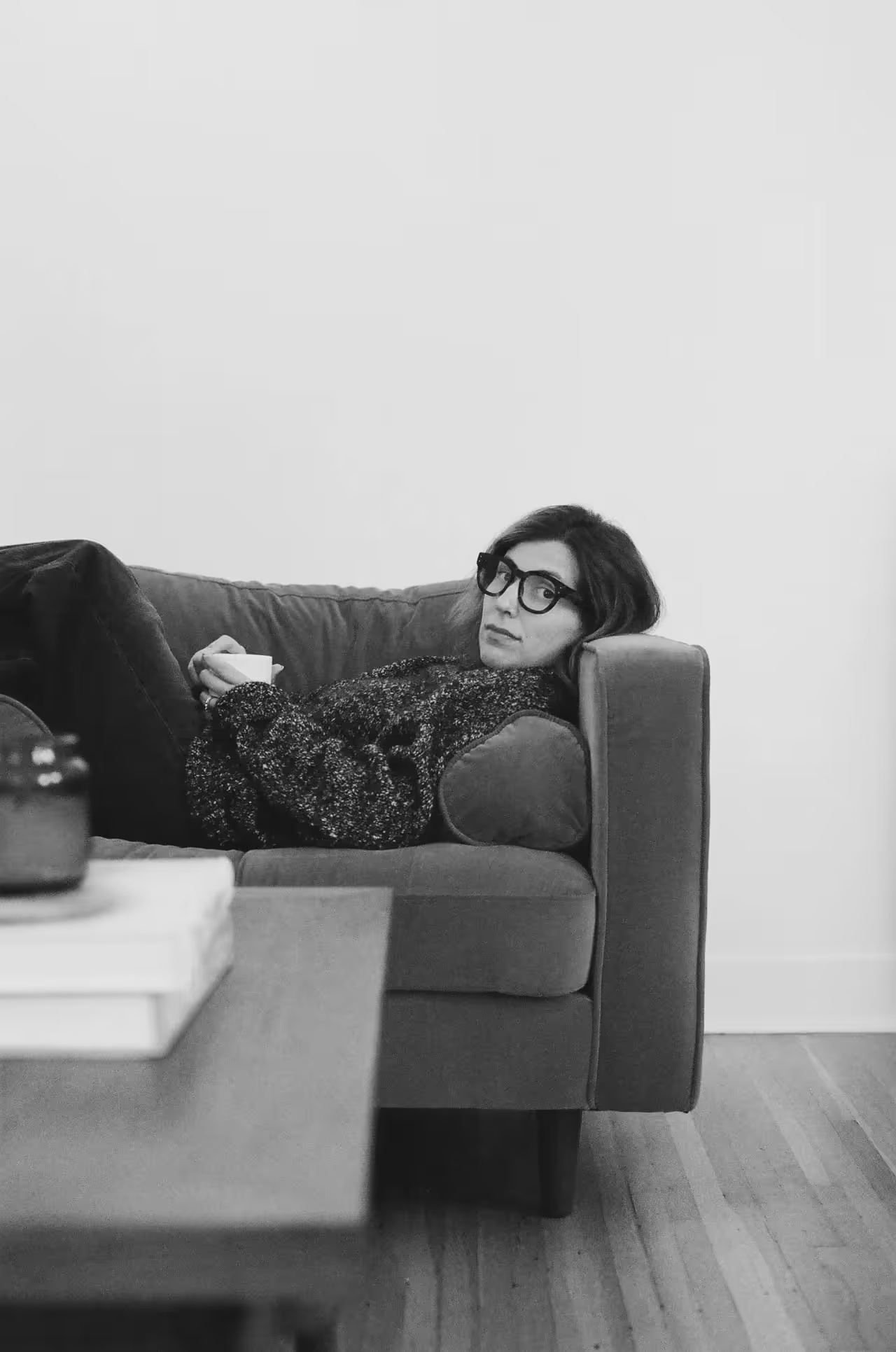 Stephanie Wittels Wachs at home, reclining on a sofa with a cup
