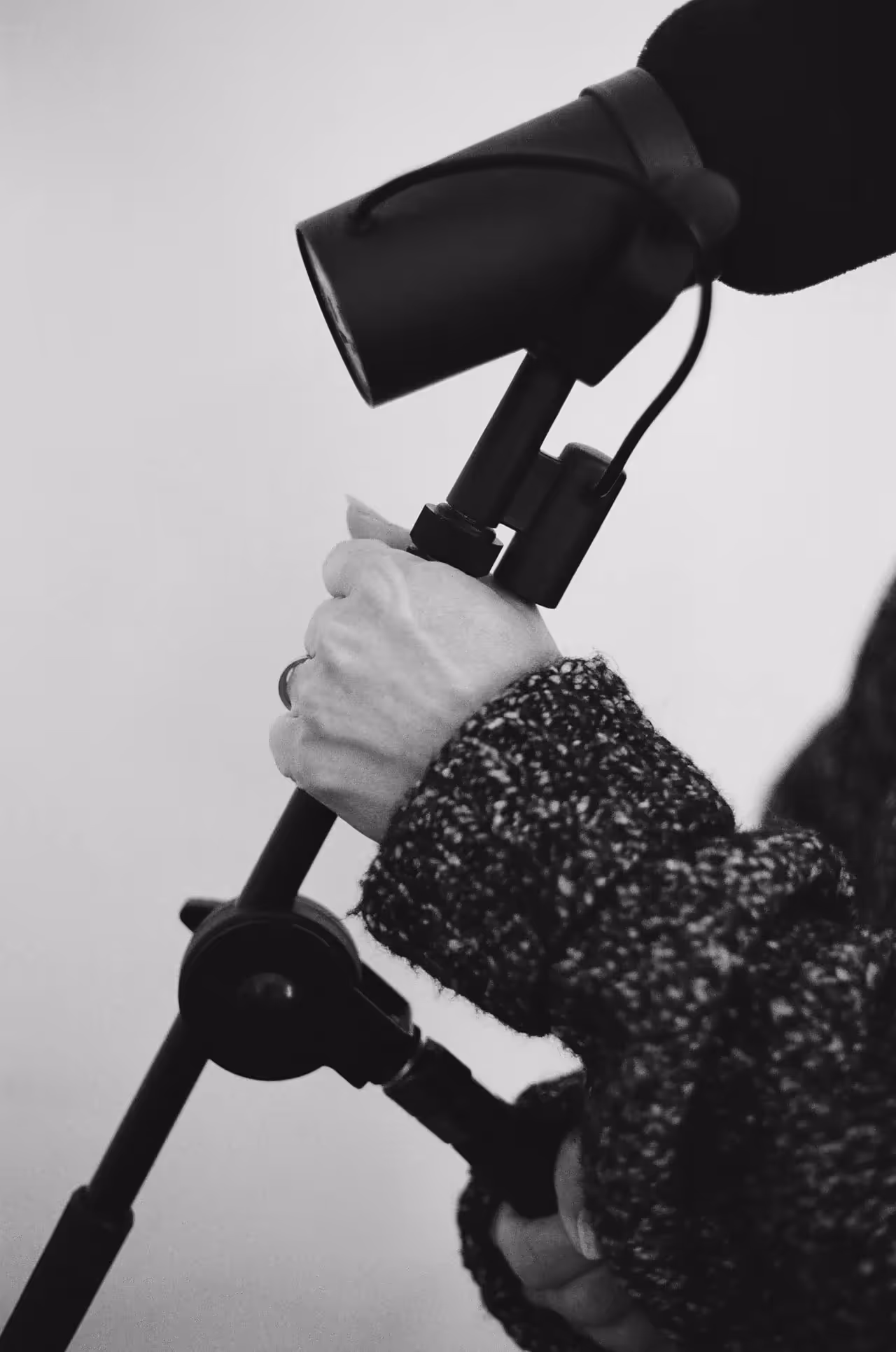 Wachs’s hand holding a microphone stand in the recording studio