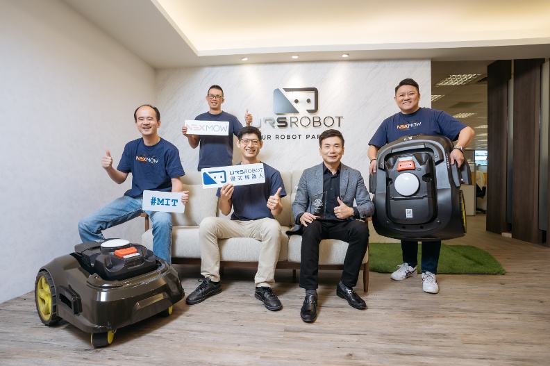 Stephen Chen, seated second from right, with URSROBOT colleagues and robotic mowers
