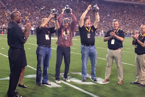 Steve Butterfield celebrates on the field with fellow ASU stadium campaign supporters