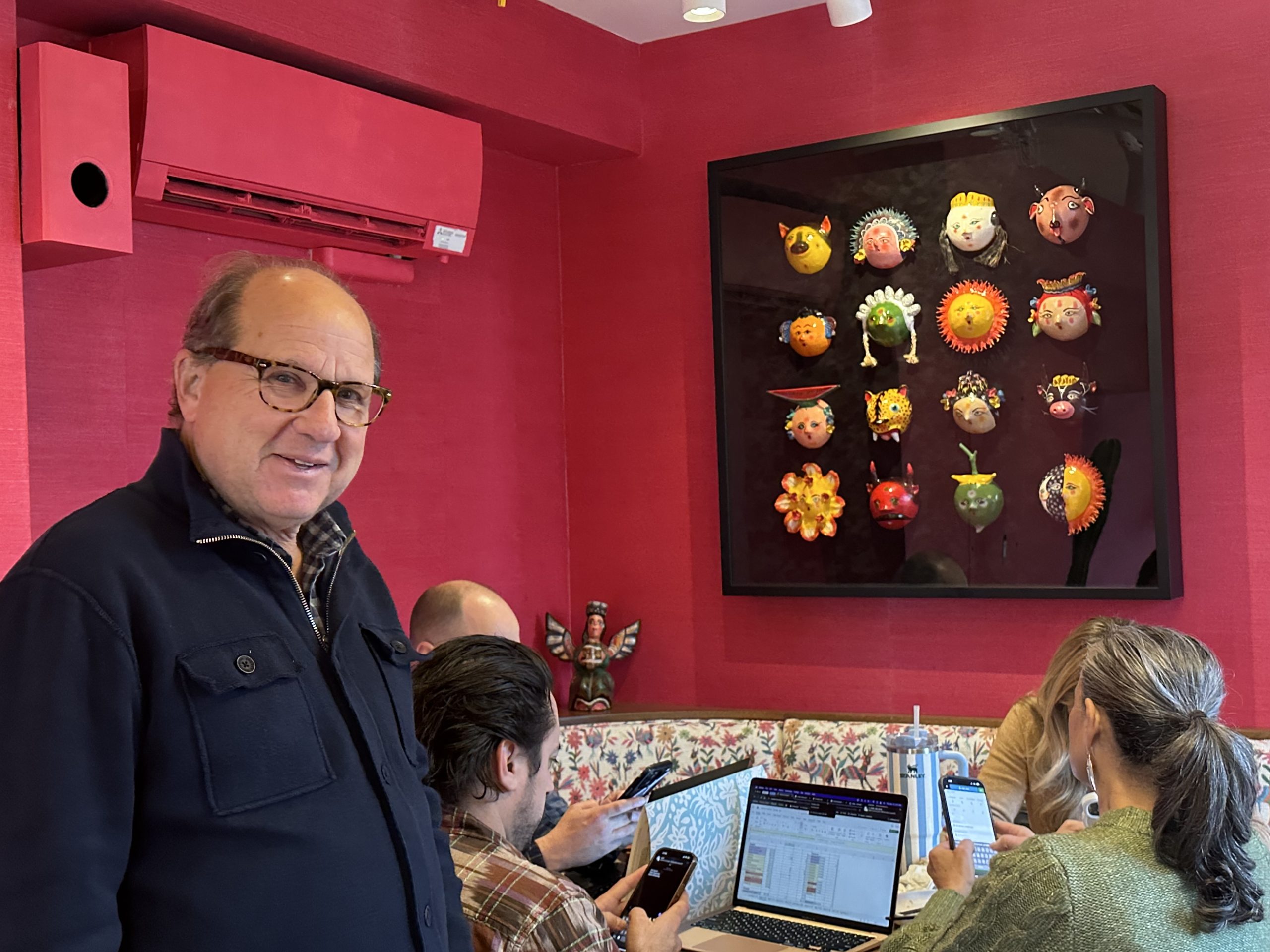 Steve Silverstein with his management team at the National Club, beside a wall of coconut masks