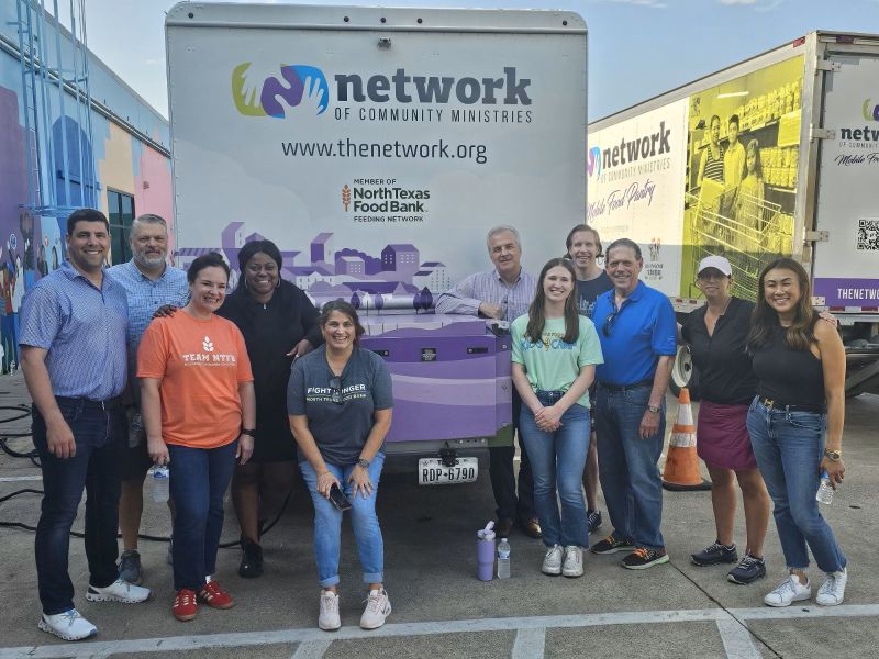 Community-pantry volunteers gathered beside a Network of Community Ministries truck
