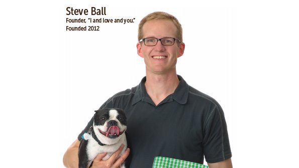 Steve Ball in an early I and love and you brand photograph, holding a dog