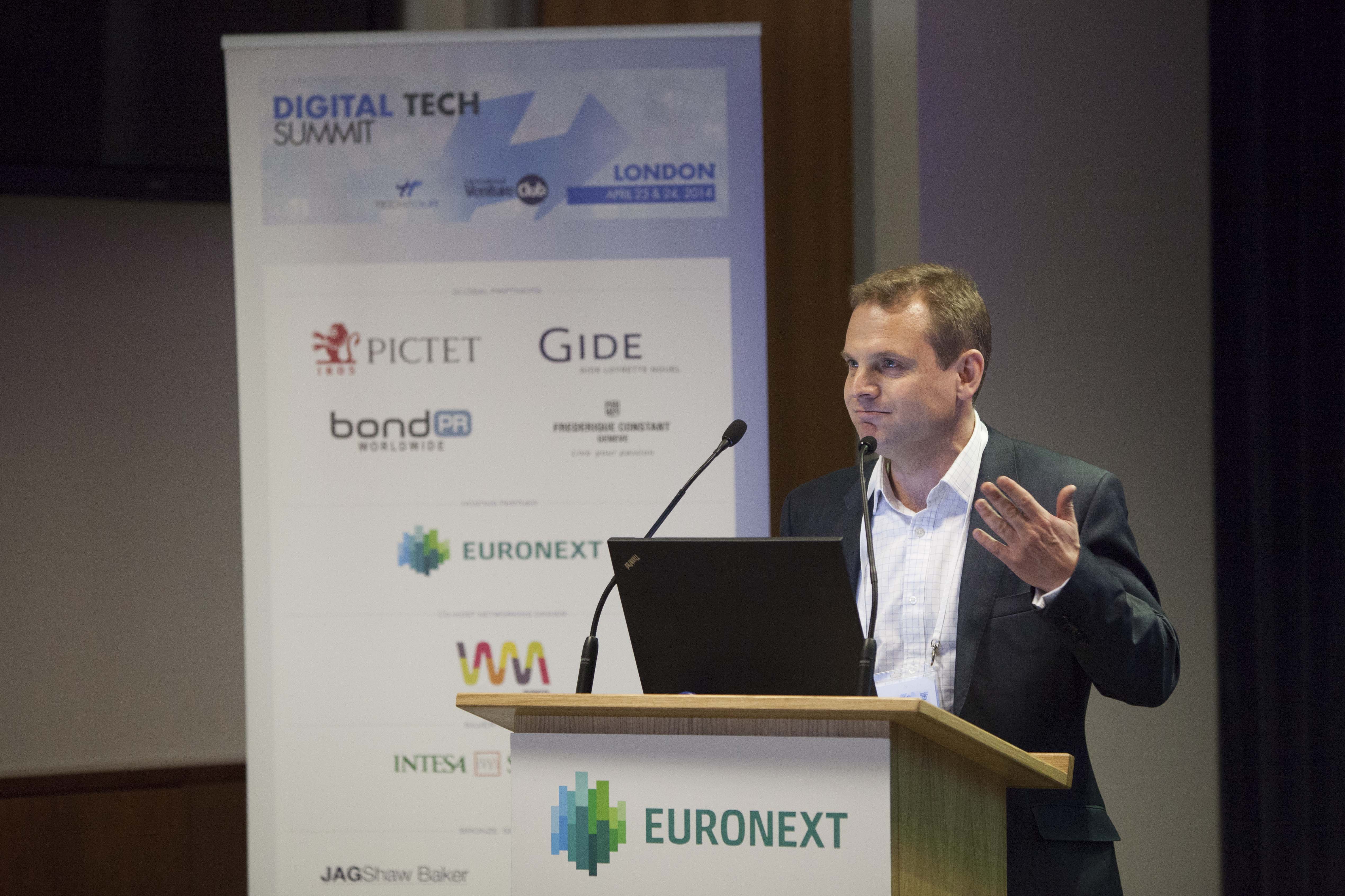 Steve Flavell speaking at a lectern at the Digital Tech Summit in London