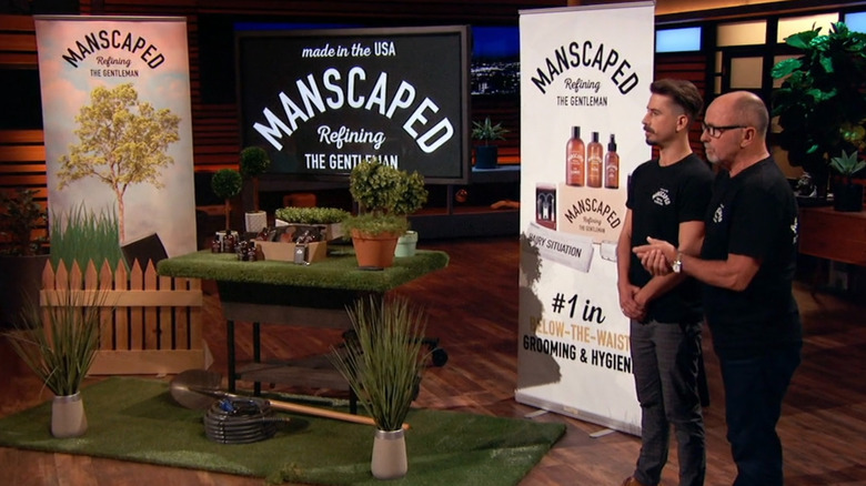 Josh King and Steve King beside MANSCAPED's garden-themed Shark Tank product display