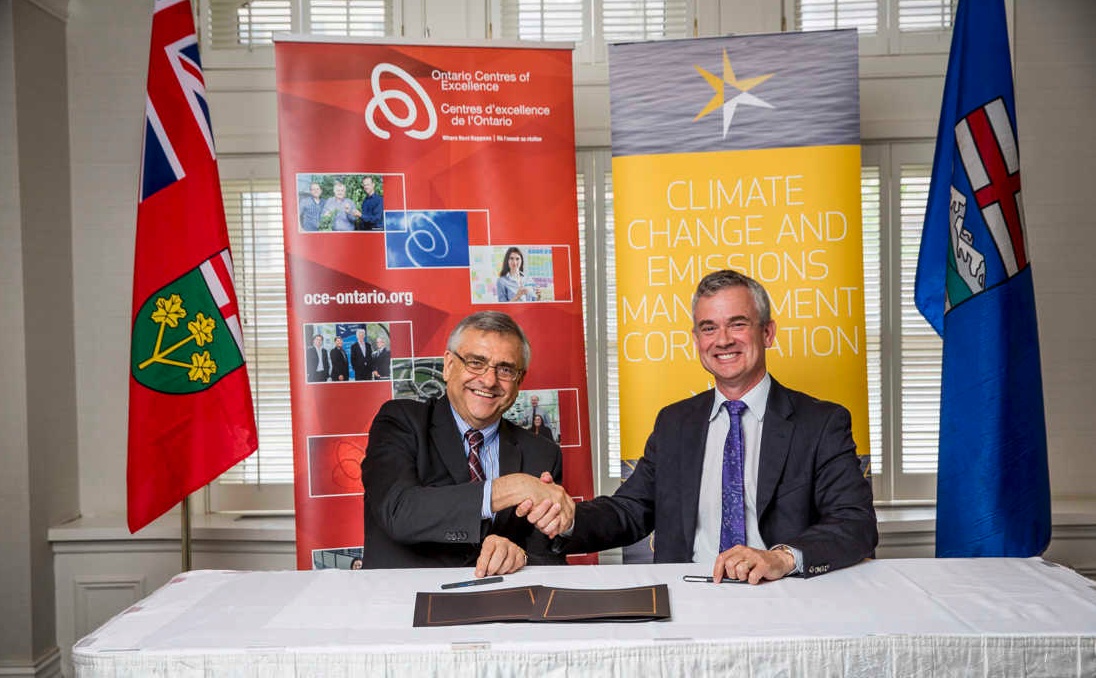 Steve MacDonald, right, and Tom Corr shake hands at their 2016 memorandum signing.