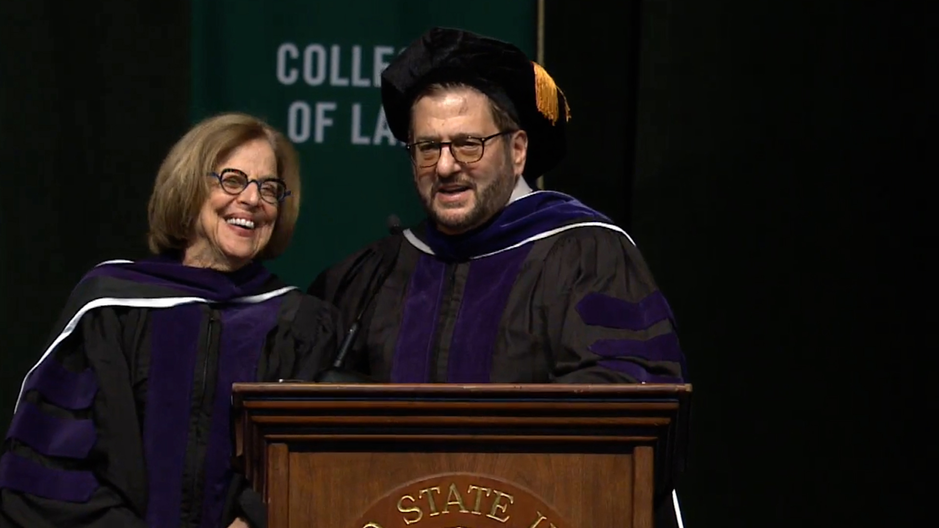 Loree and Steve Potash sharing the podium at Cleveland State University’s 2023 law commencement
