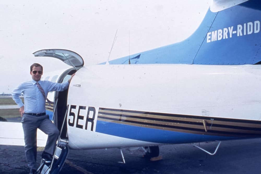 Steve Sliwa beside an Embry-Riddle aircraft during his presidency