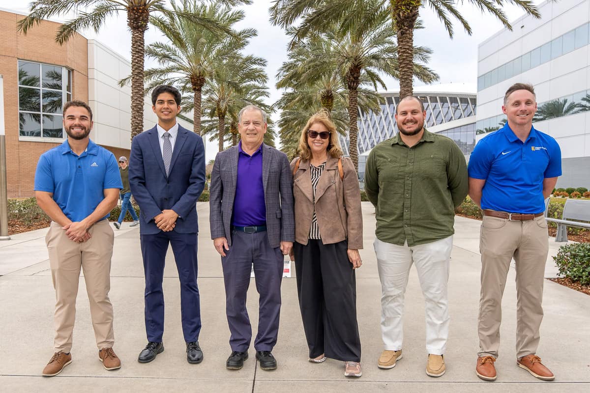 Steve and Nancy Sliwa standing with three Embry-Riddle students