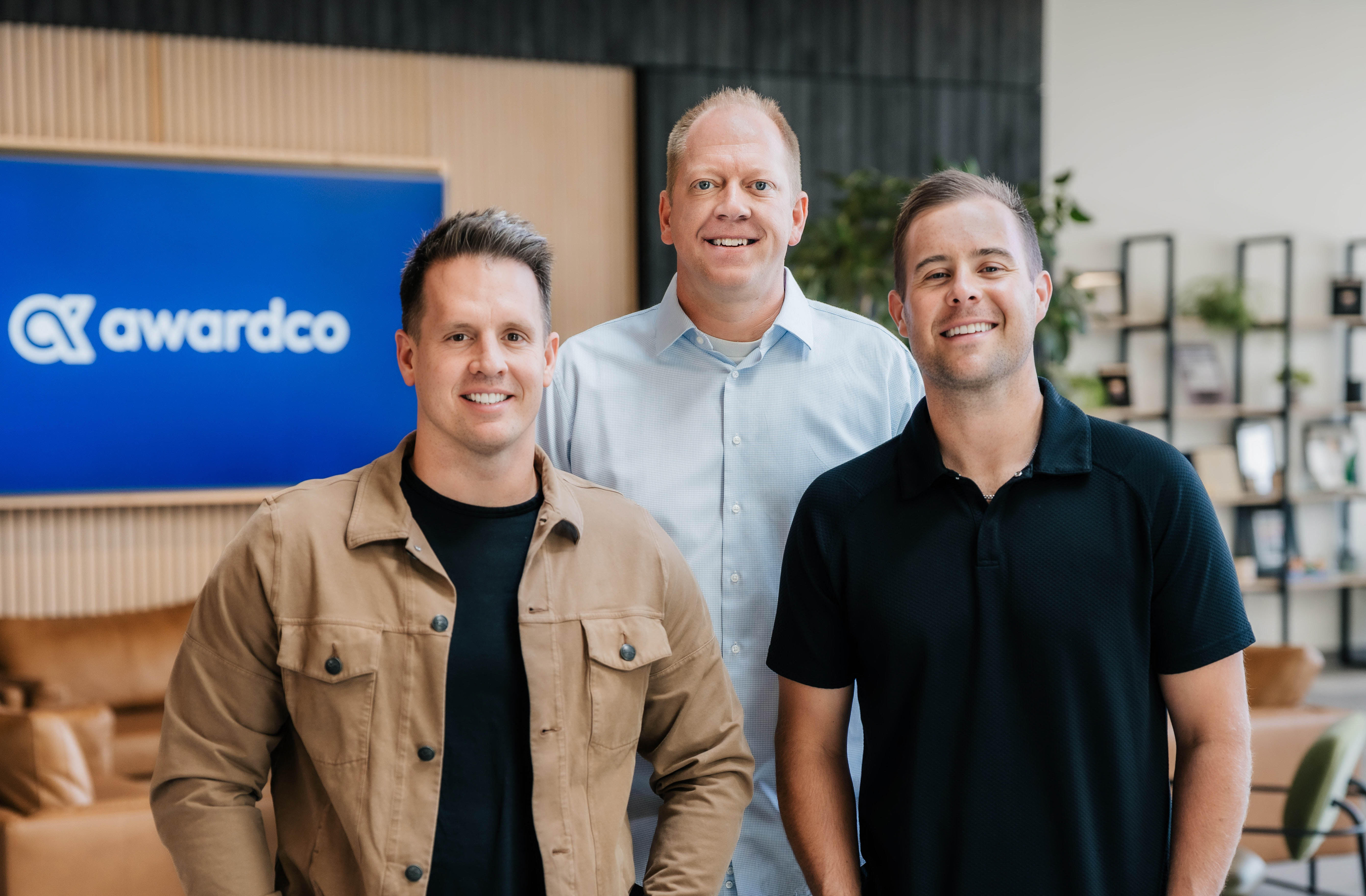 Awardco co-founders Steve Sonnenberg, Mike Sonnenberg and Tanner Runia standing together in the company's office