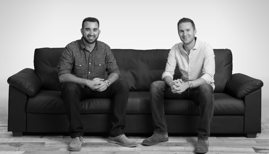 Steve Voudouris on the left and his brother Andrew seated on a black sofa
