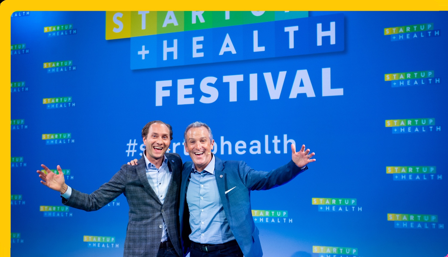 Unity Stoakes, left, and Steven Krein, right, smiling together on a festival stage