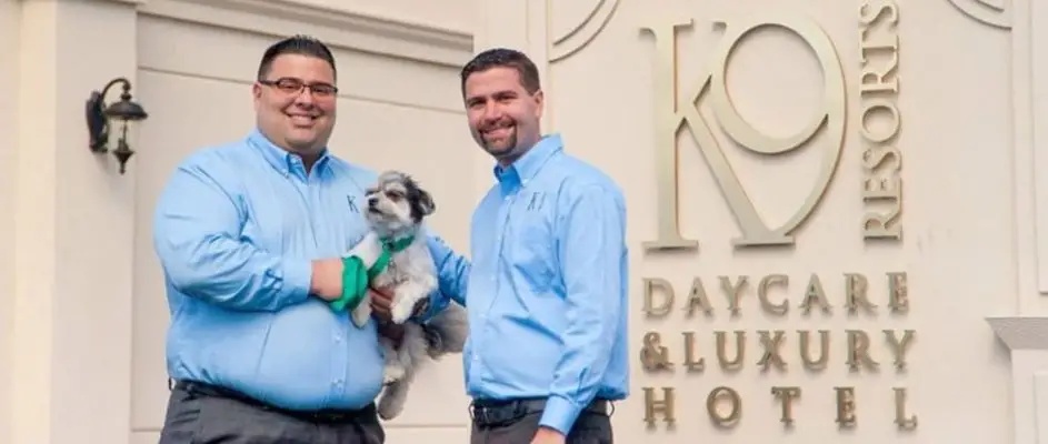 Steven Parker, left, and Jason Parker outside K9 Resorts with a small dog