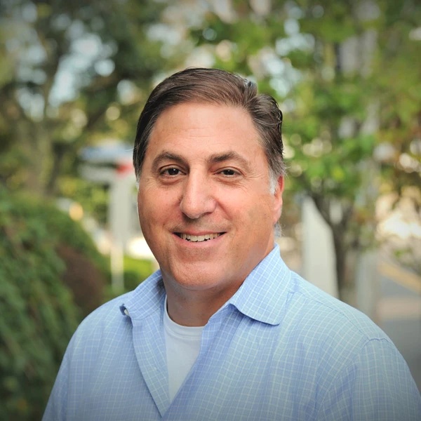 Steven Price in a blue checked shirt, photographed outdoors for Townsquare Media