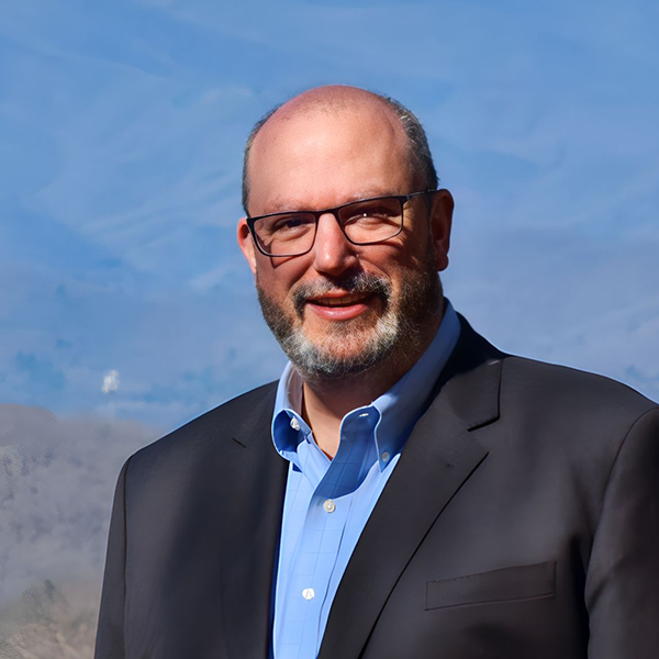 Morgan Stewart, founder of Stewart Communications, in front of a mountain backdrop