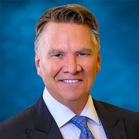 Official portrait of Stifel chairman and CEO Ron Kruszewski in a dark suit and blue tie