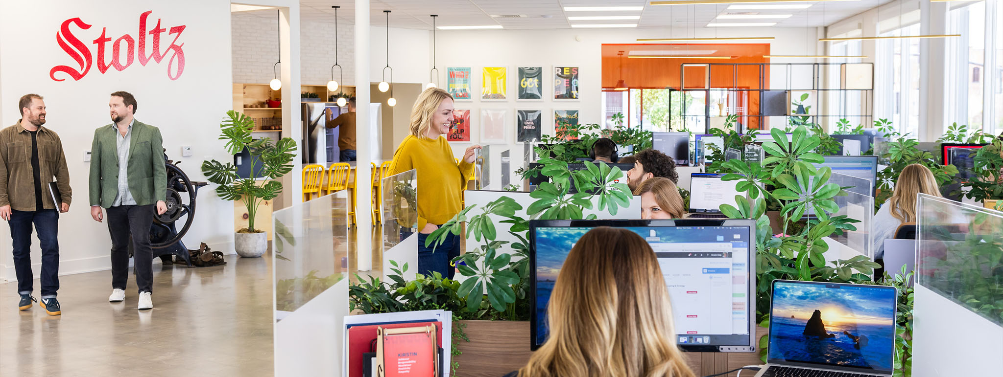 The Stoltz Marketing Group team working in a bright, plant-filled Boise office