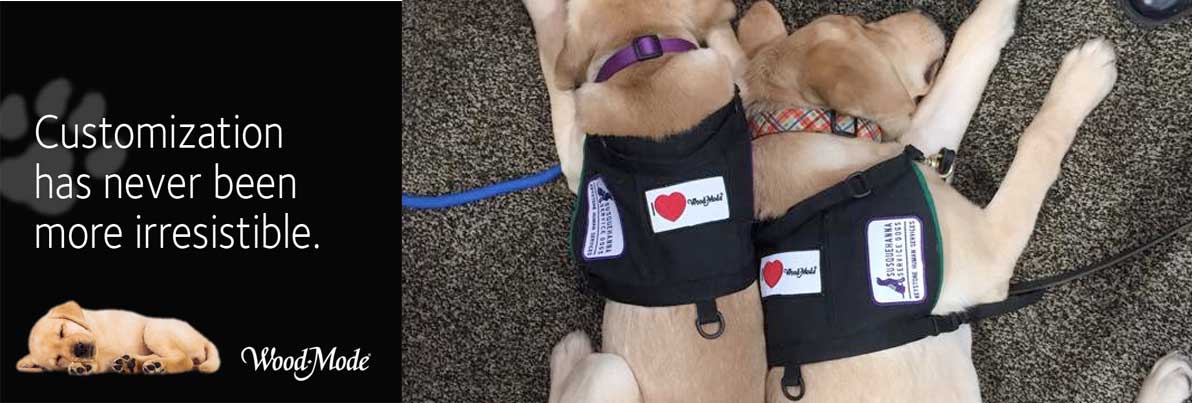 Service dogs wearing Wood-Mode campaign vests at the KBIS trade show