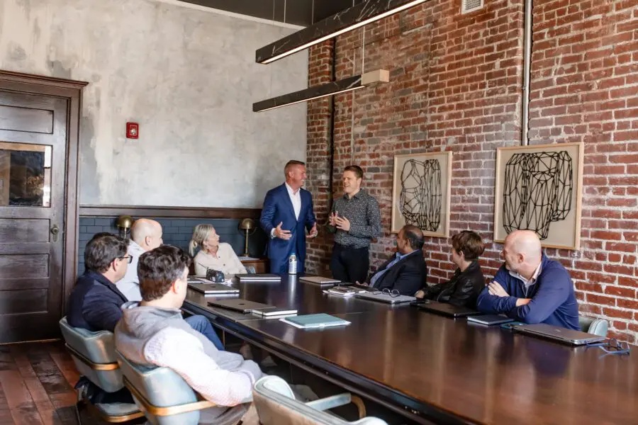 People meeting around a conference table in a photograph published by Storable