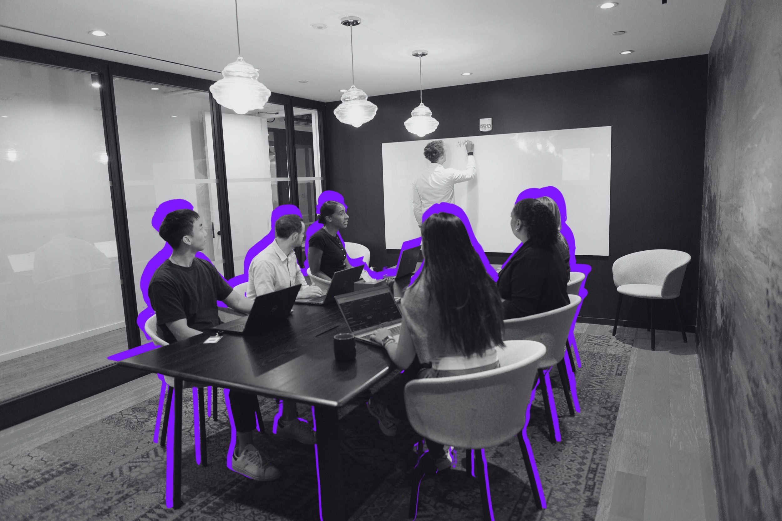 Storm3 promotional photograph of colleagues around a meeting table, with purple outlines
