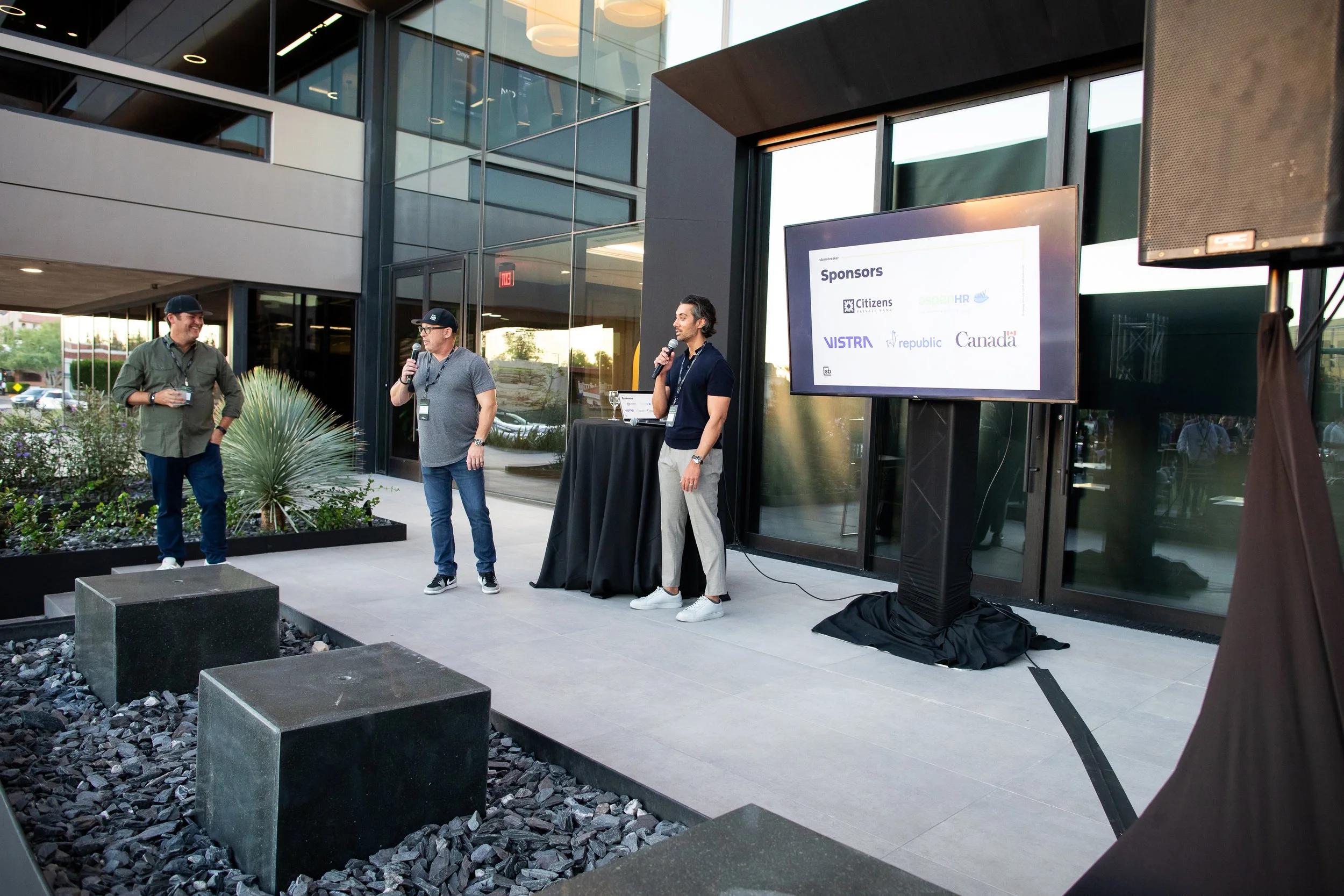 Speakers with microphones at Stormbreaker’s annual meeting