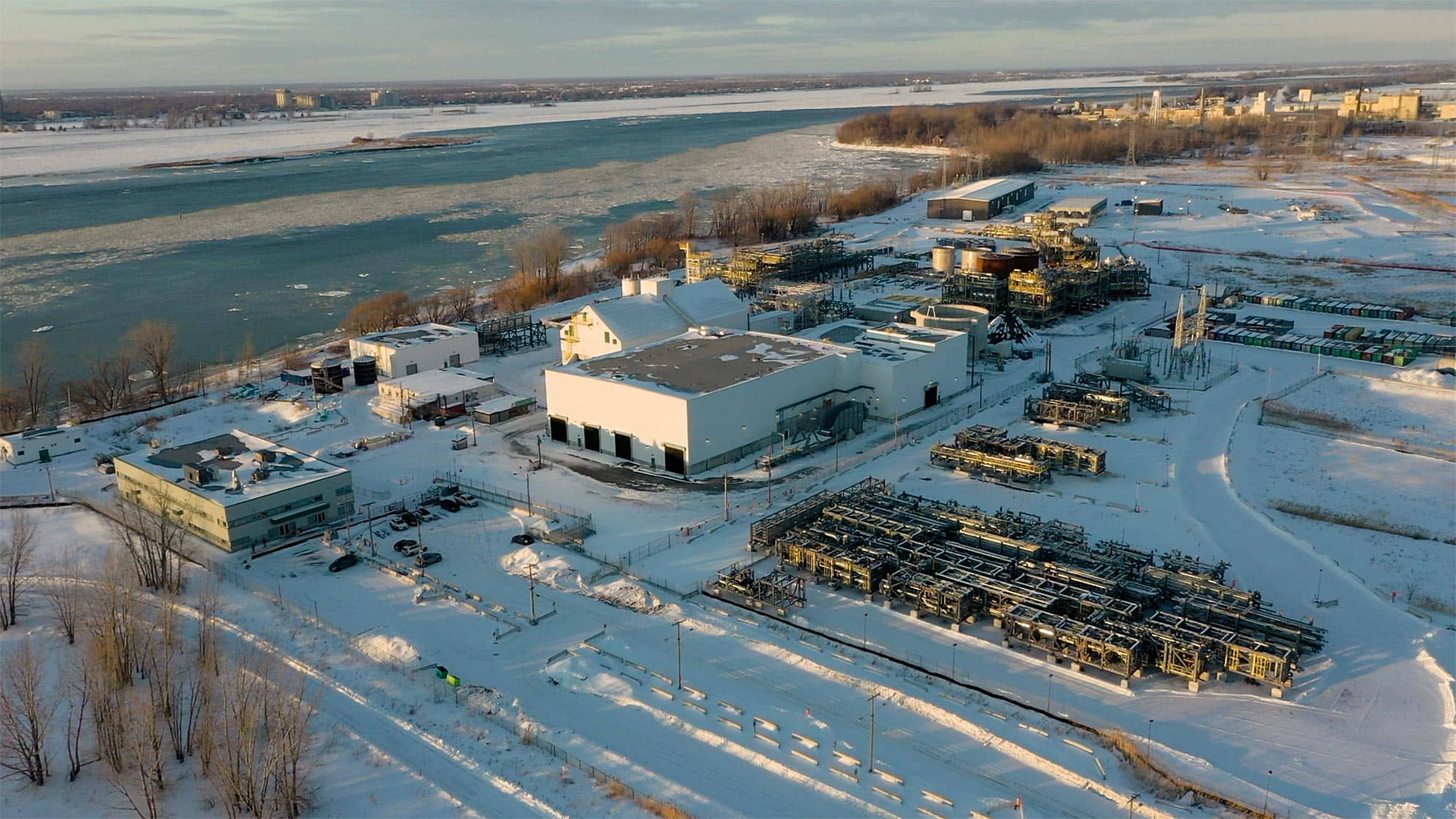 Aerial view of the snow-covered StormFisher Varennes industrial site beside the St. Lawrence River