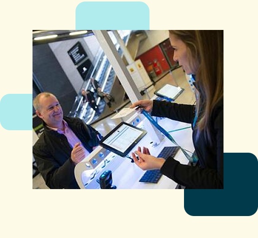 An attendee and staff member using a Stova check-in station