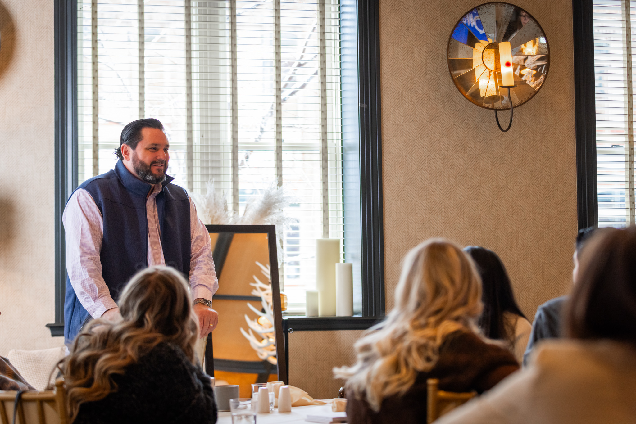 A Strategic Elements team member speaking to colleagues during a company gathering