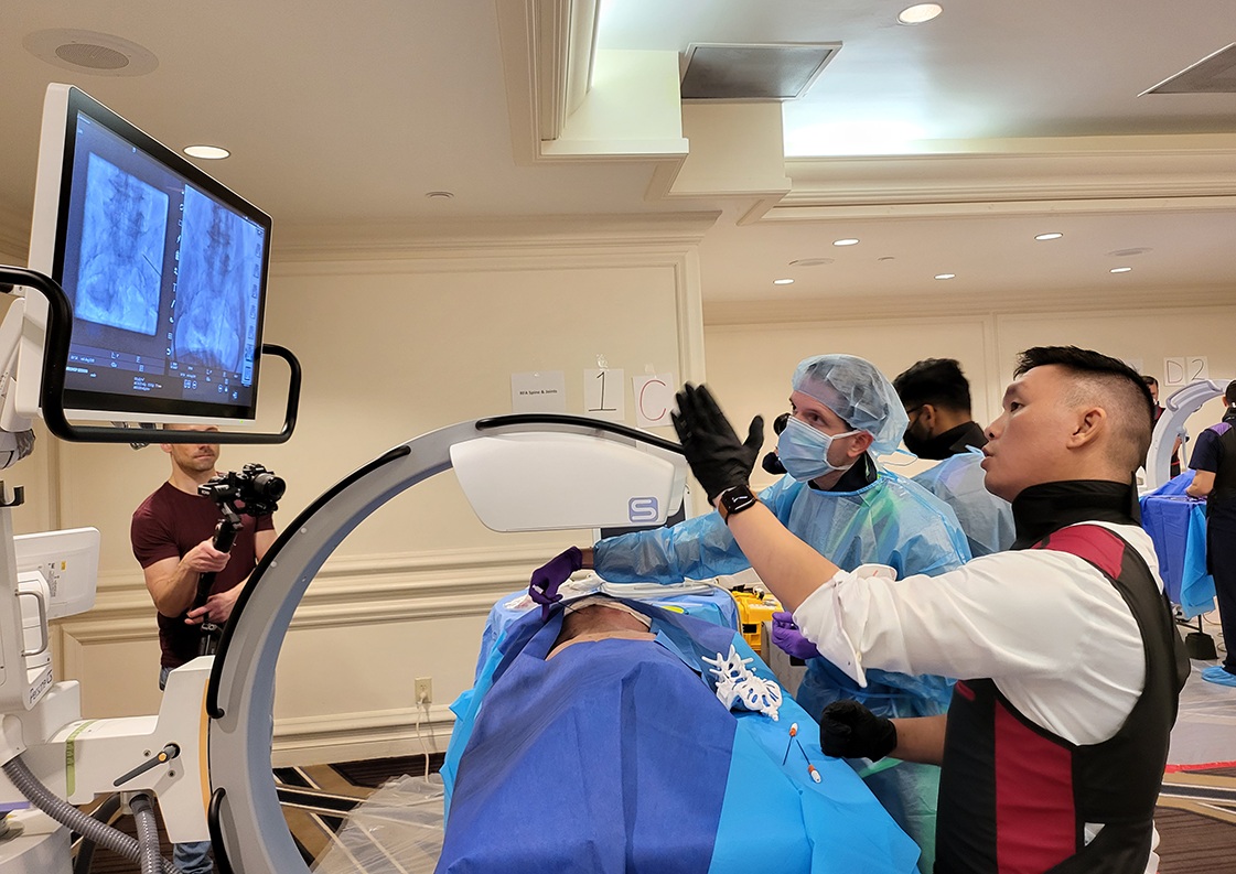 Clinicians reviewing fluoroscopic images during a hands-on training session
