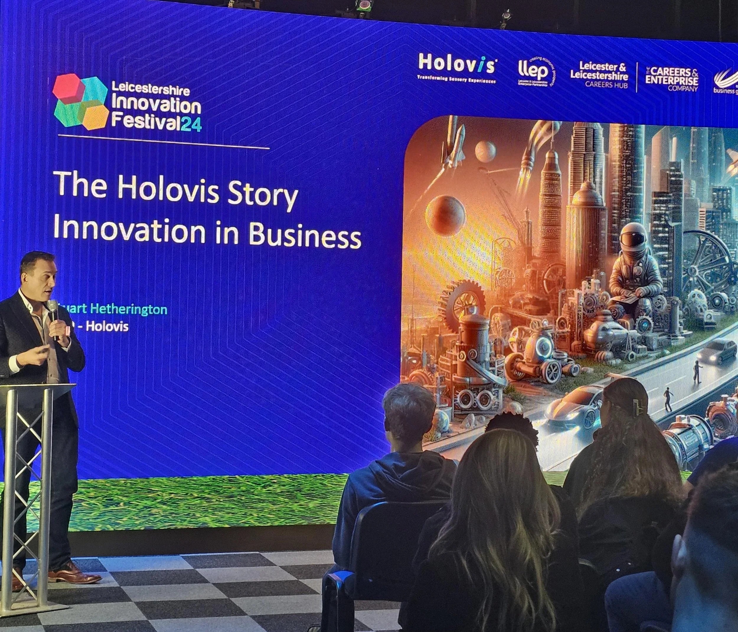 Stuart Hetherington speaking at a lectern to students during Leicestershire Innovation Festival 2024