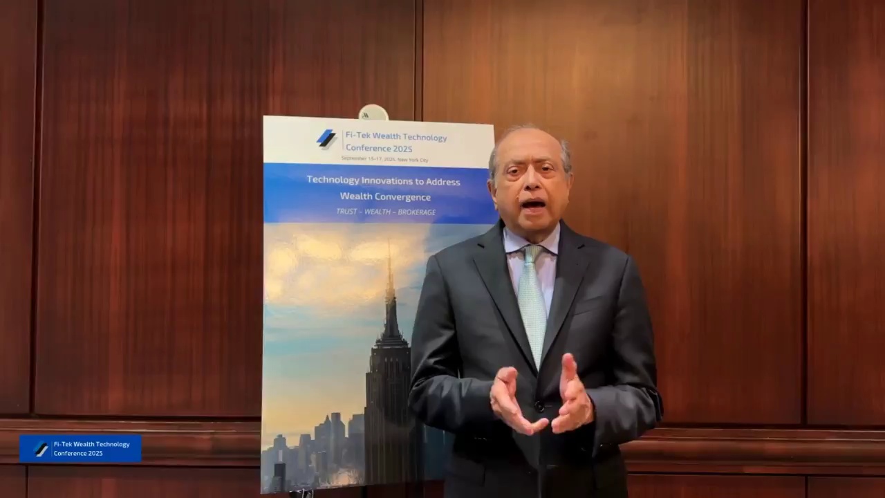 Subir Chatterjee speaks beside the Fi-Tek Wealth Technology Conference 2025 sign