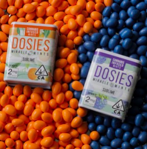 Orange and blue raspberry Dosies mint packages surrounded by colored mints