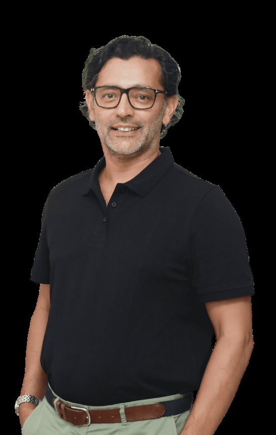 Sumir Karayi wearing glasses and a dark polo shirt