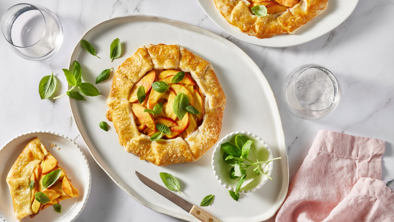 Golden fruit galettes arranged on a pale table
