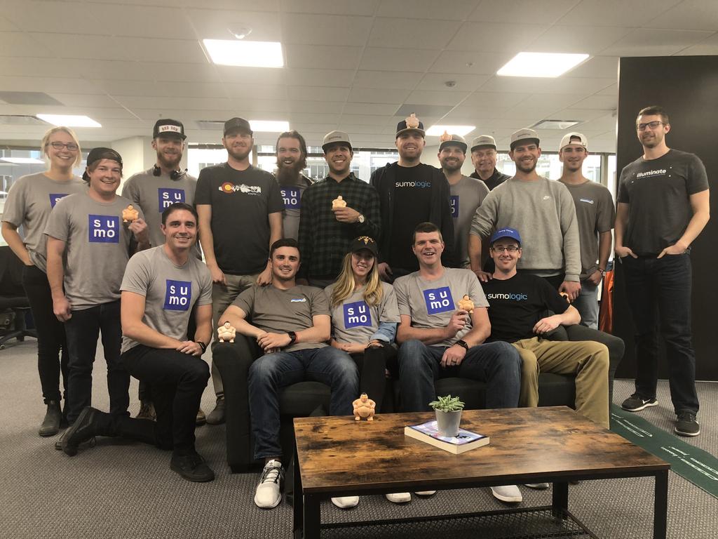 A group of Sumo Logic employees gathered in an open office