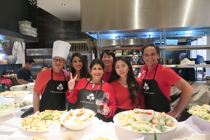 Colleagues gathered around food at the team cooking competition pictured in Ramnath’s June 2022 post