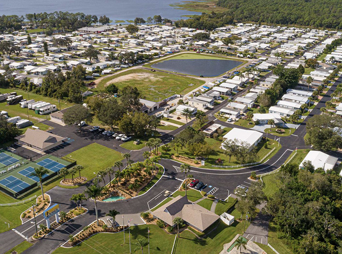 Aerial view of Buttonwood Bay with homes, roads, courts and a lake