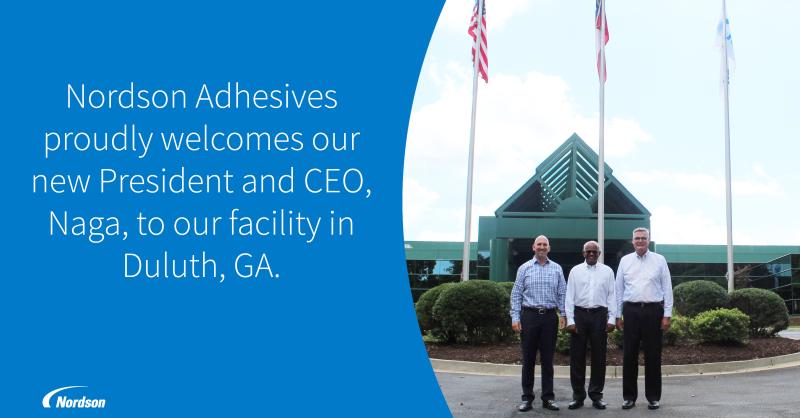 Nordson’s 2019 welcome graphic showing Sundaram Nagarajan, center, with two colleagues outside the Duluth, Georgia adhesives facility