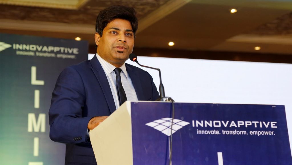 Sundeep Ravande speaking into a microphone behind an Innovapptive podium