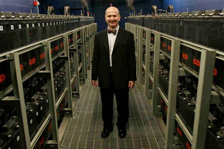 Former SunGard CEO Cristóbal Conde standing amid rows of backup batteries