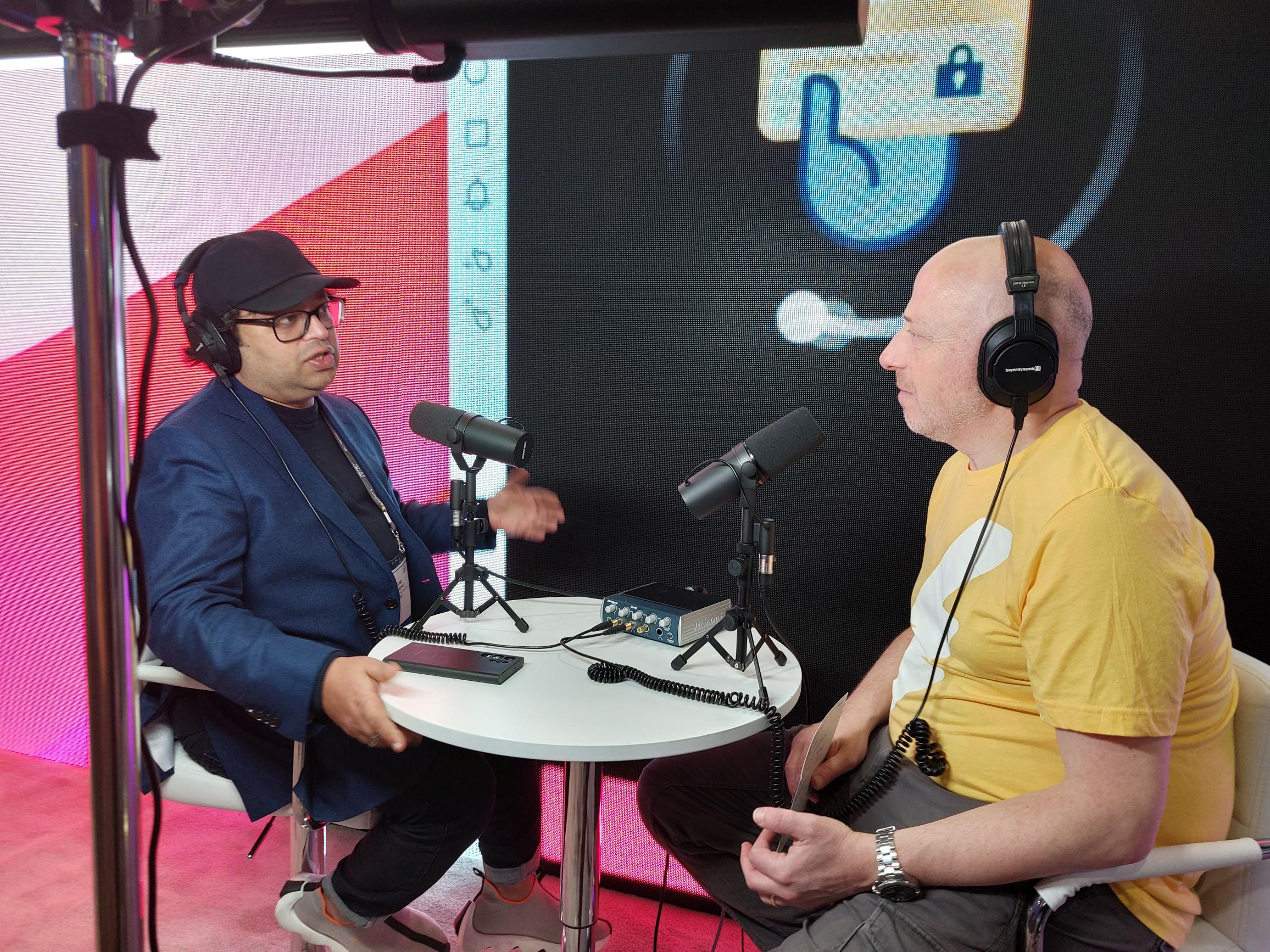 Sunil Madhu, left, speaking with a c-suite podcast interviewer at Money20/20 USA in 2023