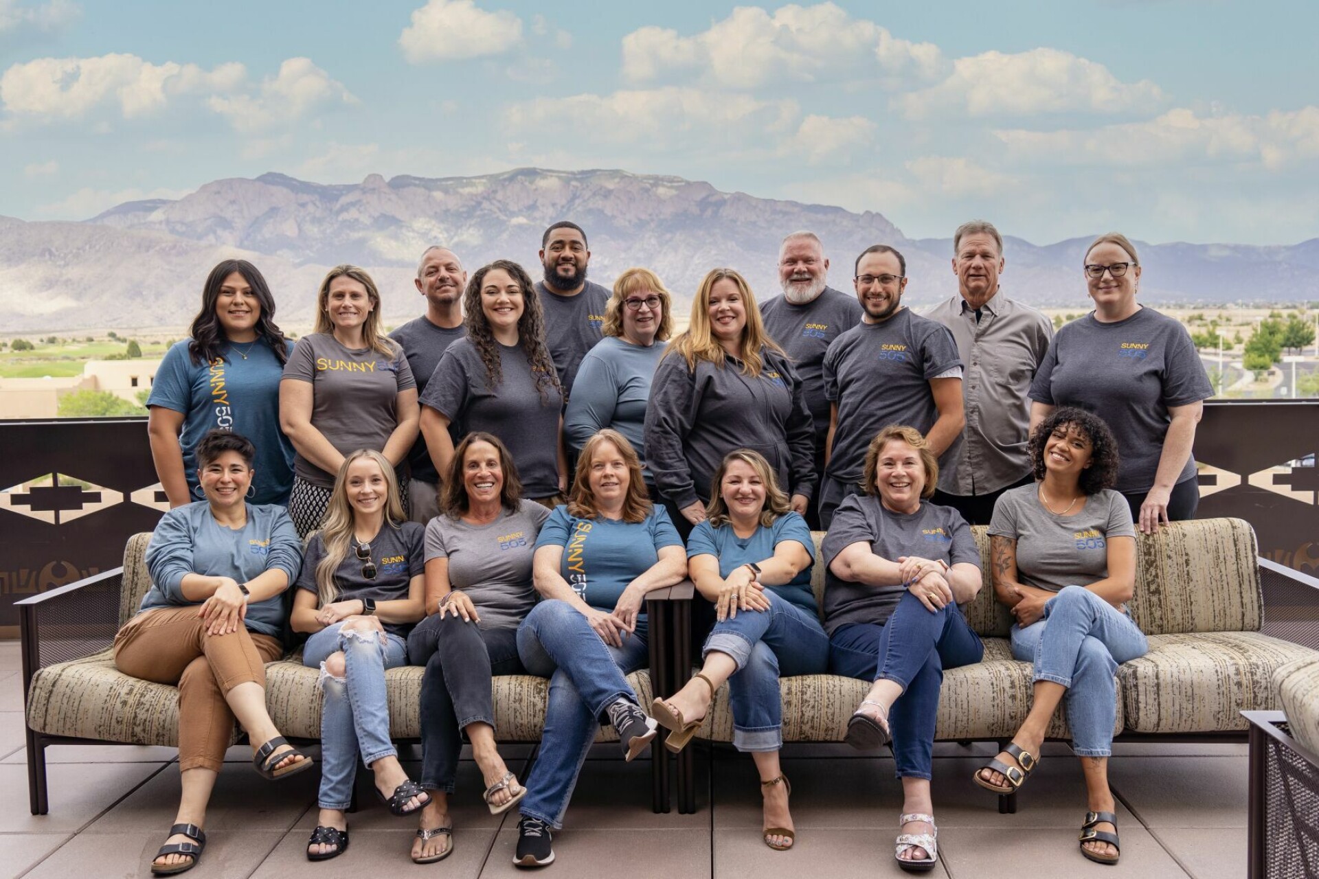 The SUNNY505 team gathered outdoors in matching shirts