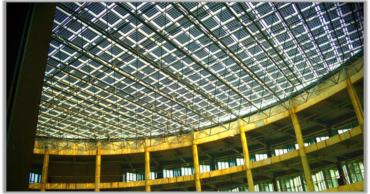 Looking up through a large roof structure fitted with Sunpreme solar panels