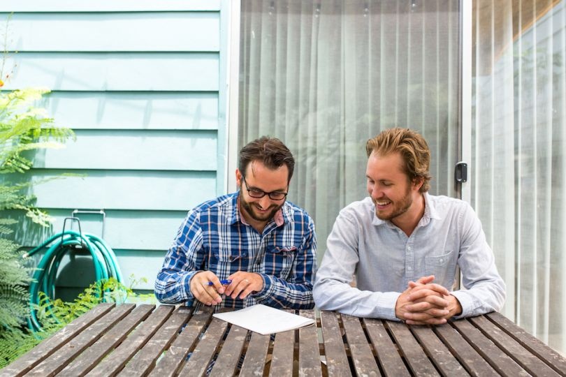Sunroom co-founders sitting together at an outdoor table